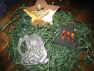 Close-up of Jesse Tree ornaments on green paper grass.