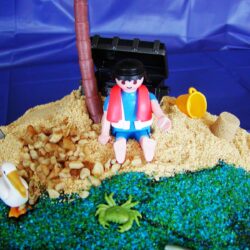 beach cake closeup of lifeguard on beach with pelican and crab toys.