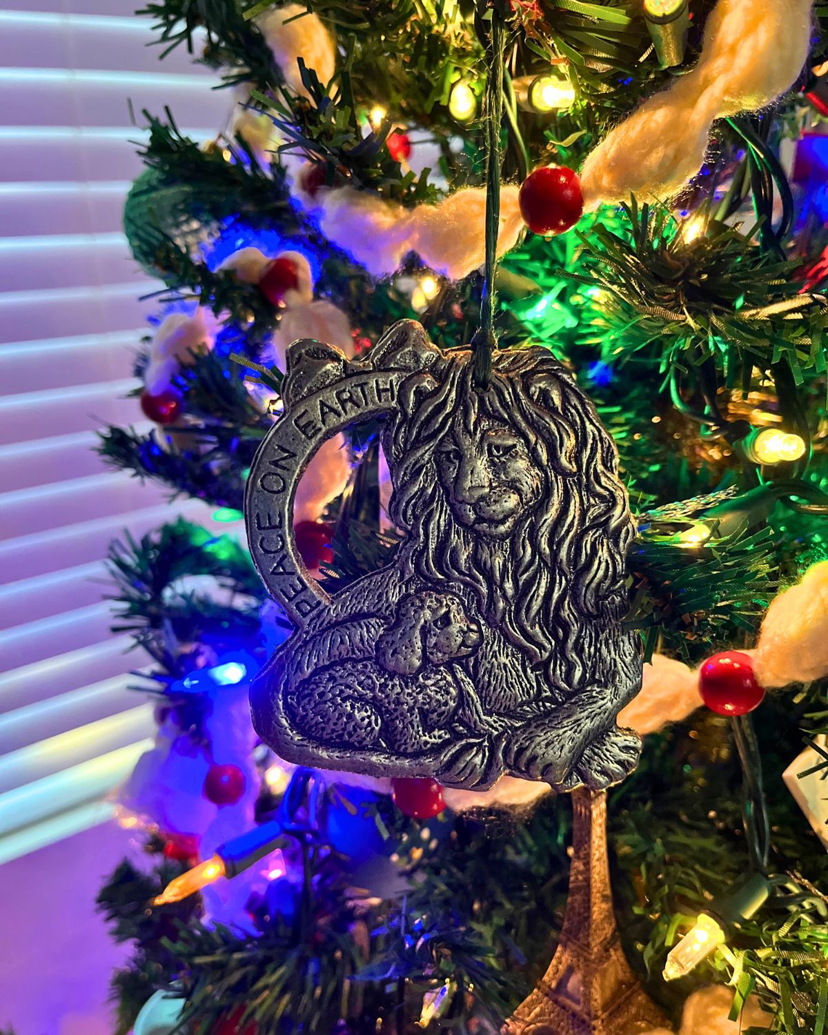 lion and lamb ornament hanging on tree.