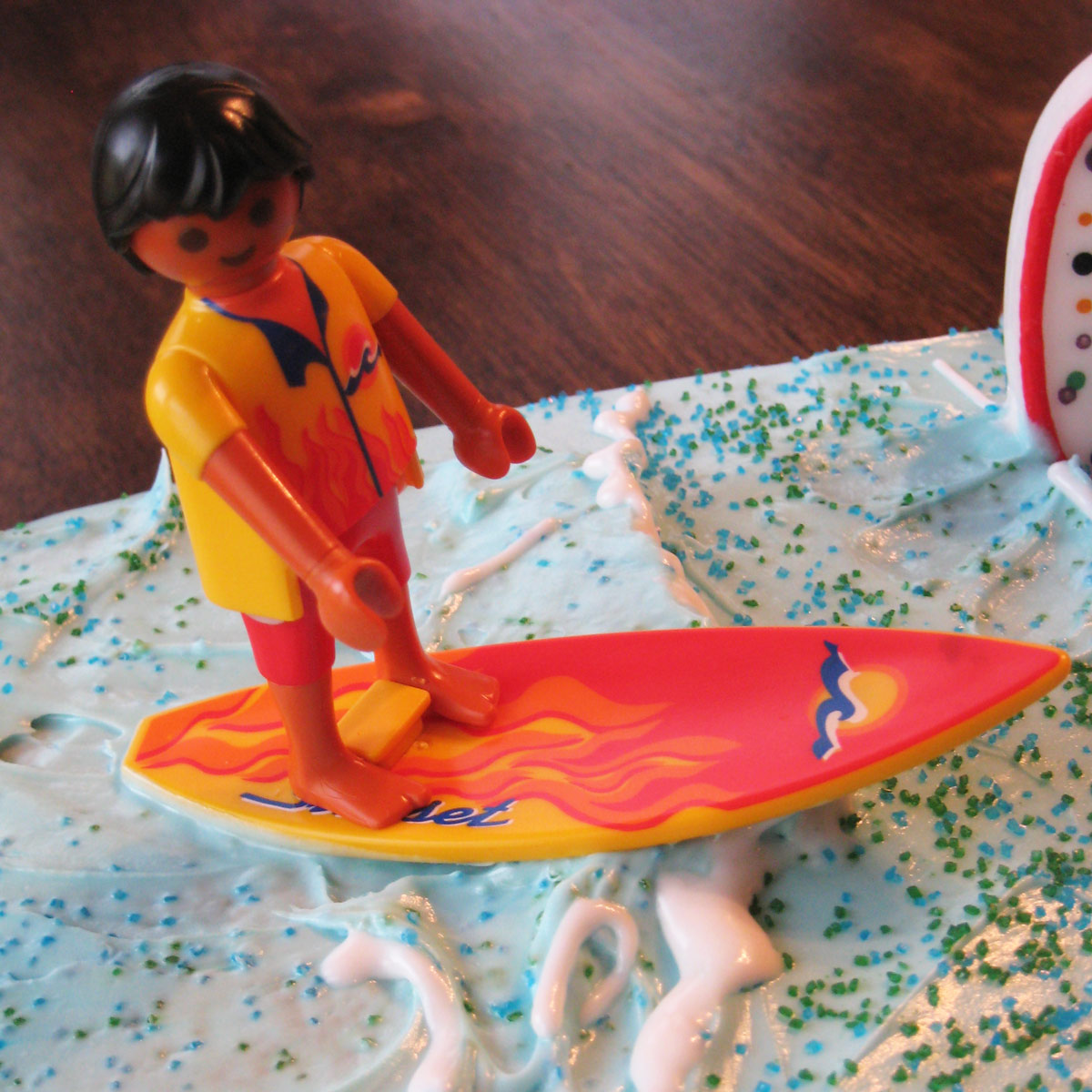 toy surfer on surfboard on frosting waves.