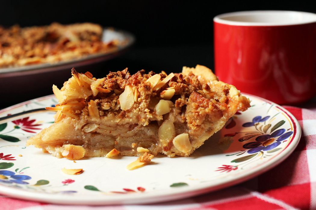slice of apple pie on plate with mug
