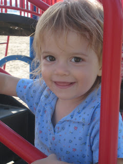 A little girl smiling at the camera.