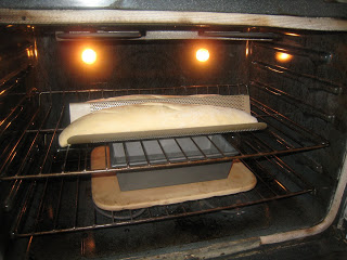 baguettes in oven with pan of water