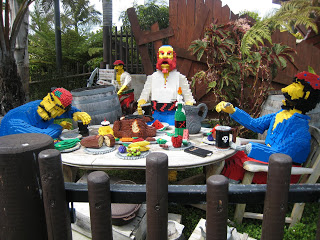 Lego formations of a group of people sitting at a picnic table.