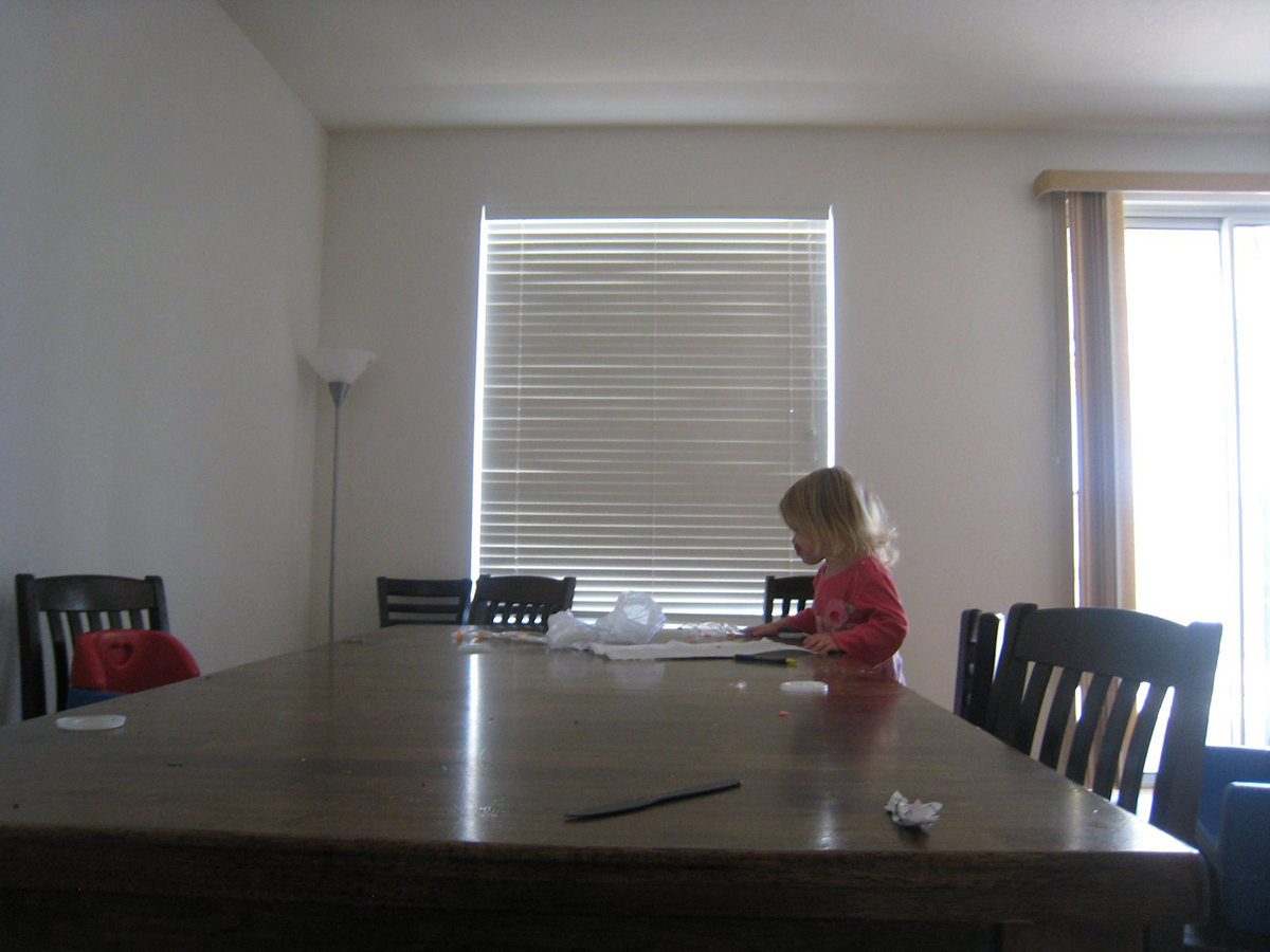 toddler girl sitting at messy table