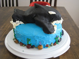 Whale cake on platter on table.