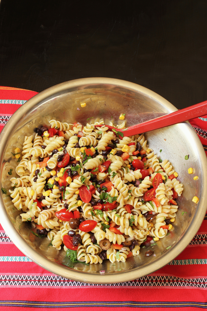 bowl of southwest pasta salad with red spoon