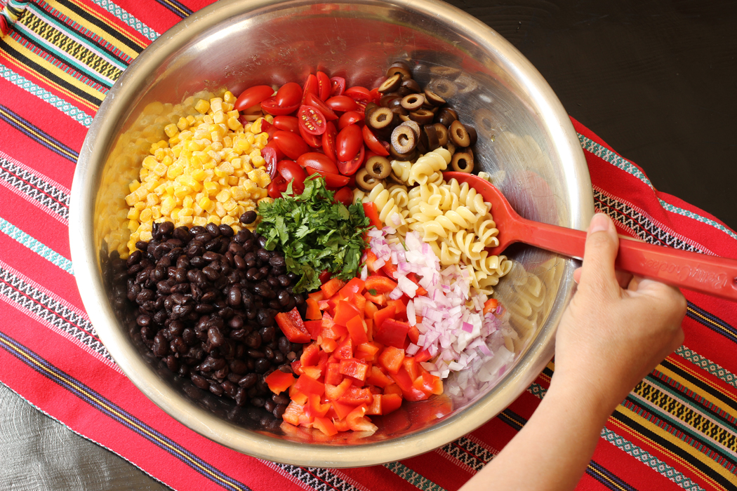 metal bowl with pasta salad ingredients