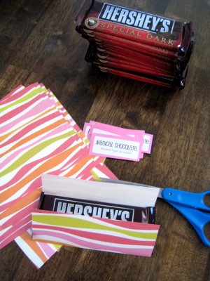 Wrapping Hershey\'s bars with striped paper.