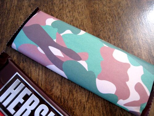 Hershey\'s bar wrapped with camouflage paper.