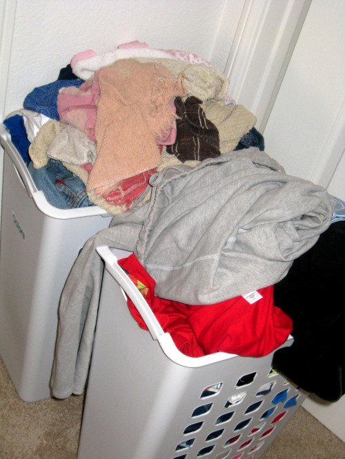 Baskets overflowing with dirty clothes.