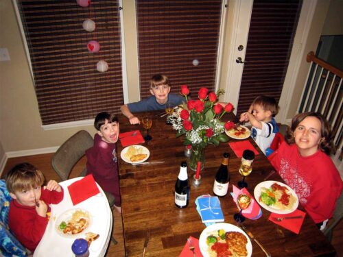 boys and mom sitting at Valentine's dinner