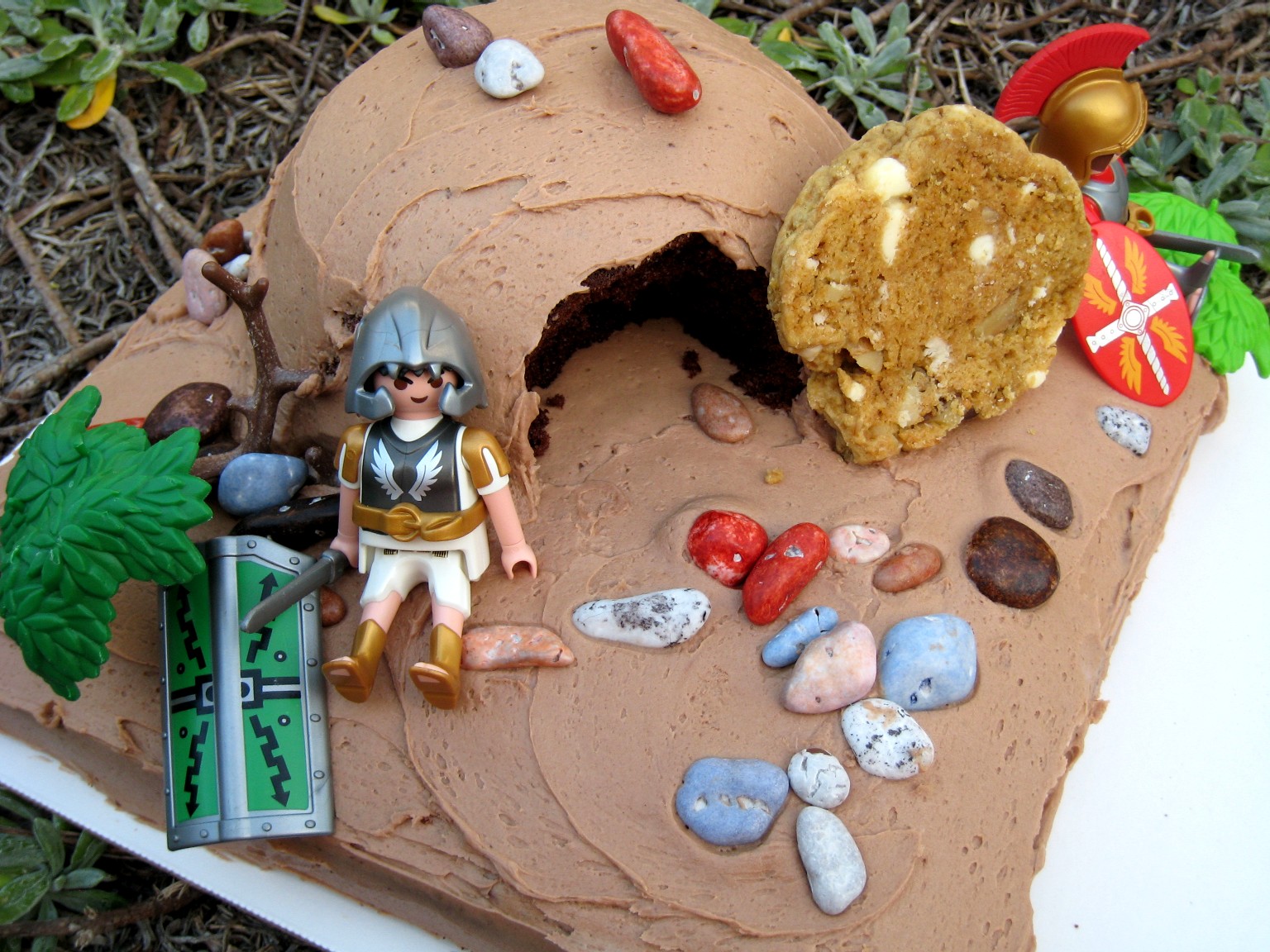 decorated empty tomb cake with candy rocks and plastic soldiers