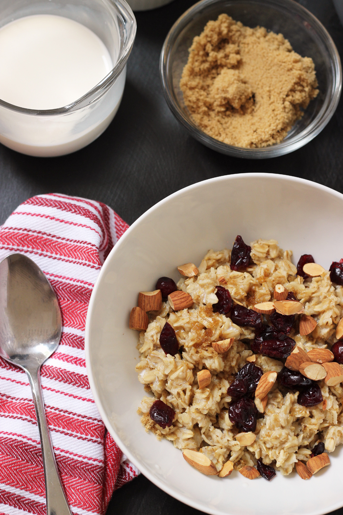 A bowl of oatmeal on table with toppings