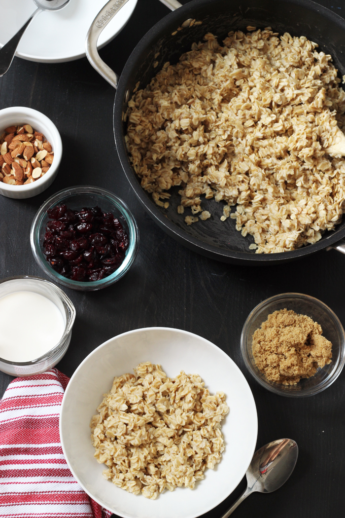 A pot of oatmeal with bowls of toppings