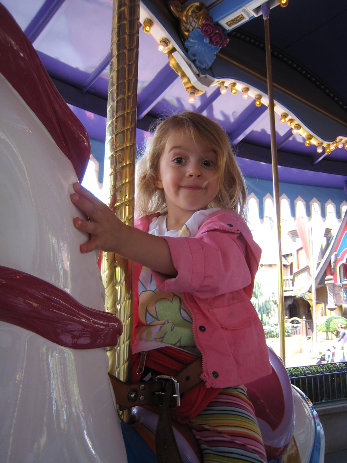happy little girl on carousel at Disneyland.
