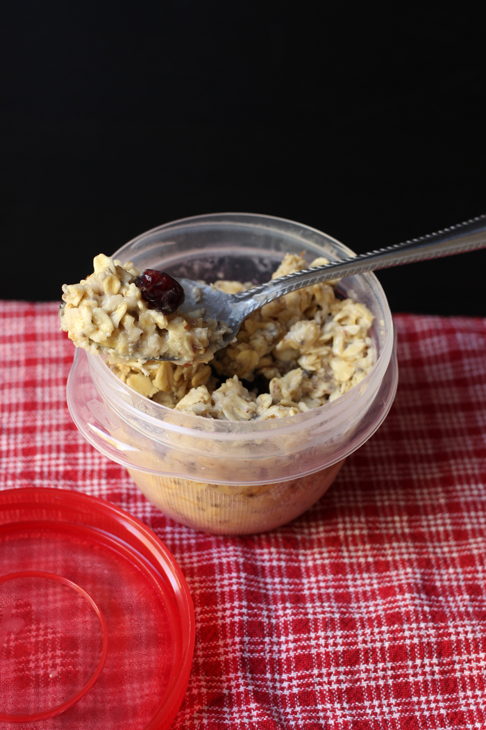 prepared bowl of instant oatmeal with spoonful of oats