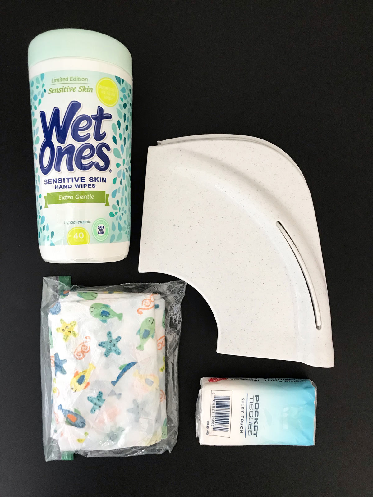 potty gear including wet ones, folding seat cover, paper seat covers, and a pack of kleenex.