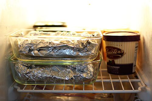 foil wrapped meals stacked in freezer