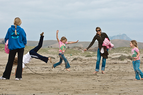 A group of people playing on a beach.