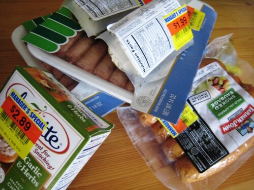 Stack of clearance groceries on kitchen table.