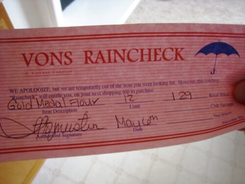 A close up of a pink Vons raincheck.