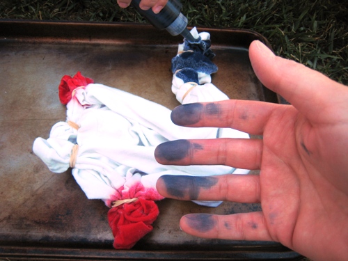 Holding a hand dyed blue near the tie dye project.