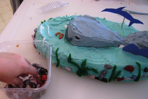A whale birthday cake on a table.