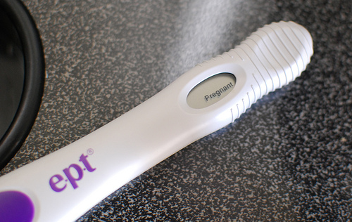 Positive pregnancy test on counter.