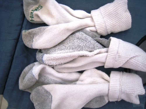Matched boys\' socks laid on bed.