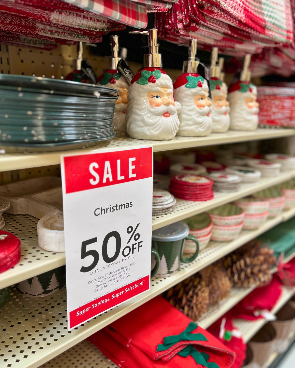 shelves of christmas decor on sale at hobby lobby for 50% off.