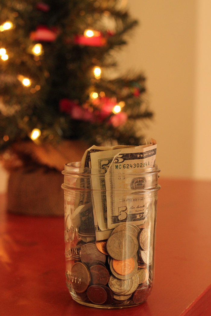 christmas tree with lights and jar of money