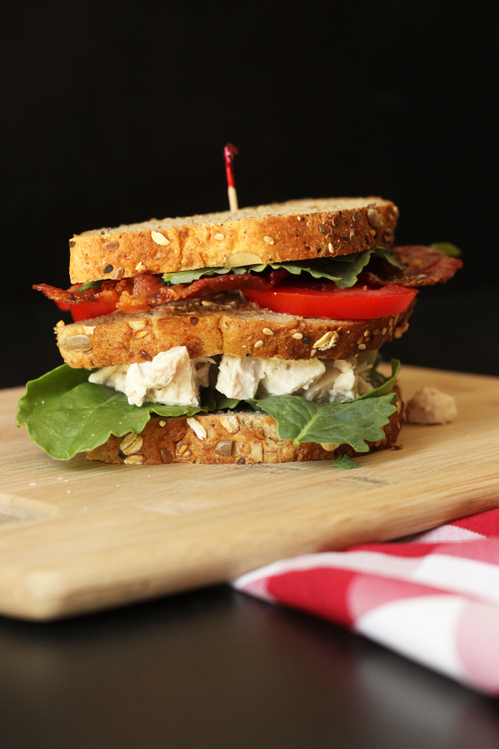 three layer club sandwich with chicken salad, bacon, lettuce, and tomatoes