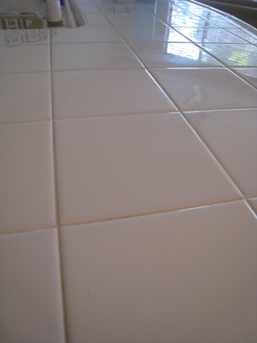 A close up of a tiled kitchen counter.
