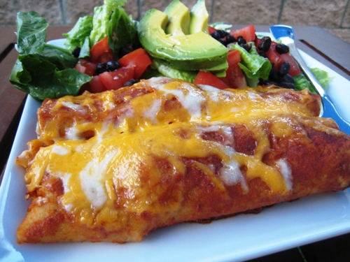 A plate of enchiladas and salad