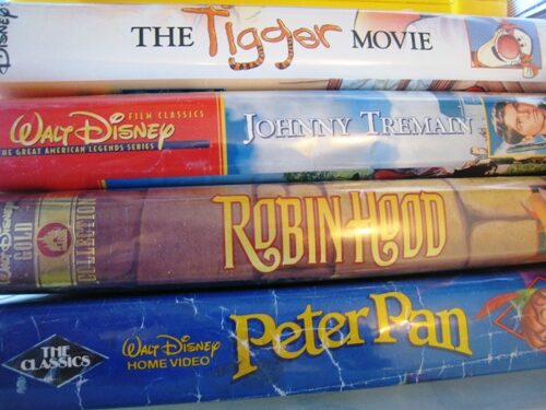 Stack of VHS tapes of Disney movies.