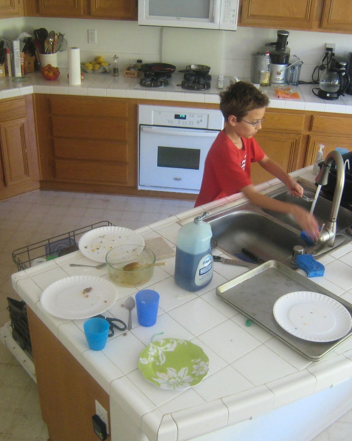boy doing dishes.
