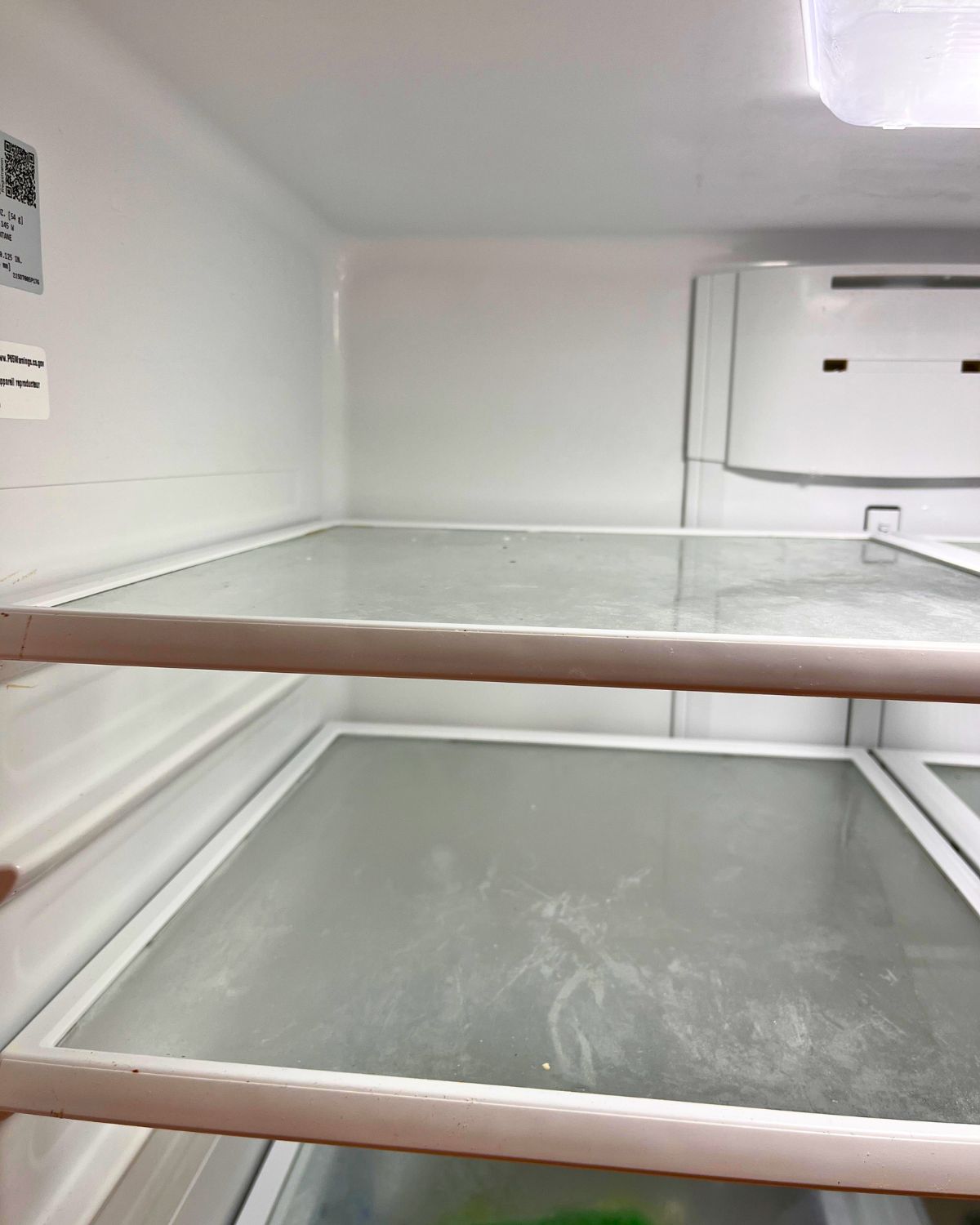 empty fridge that needs a wipe down.