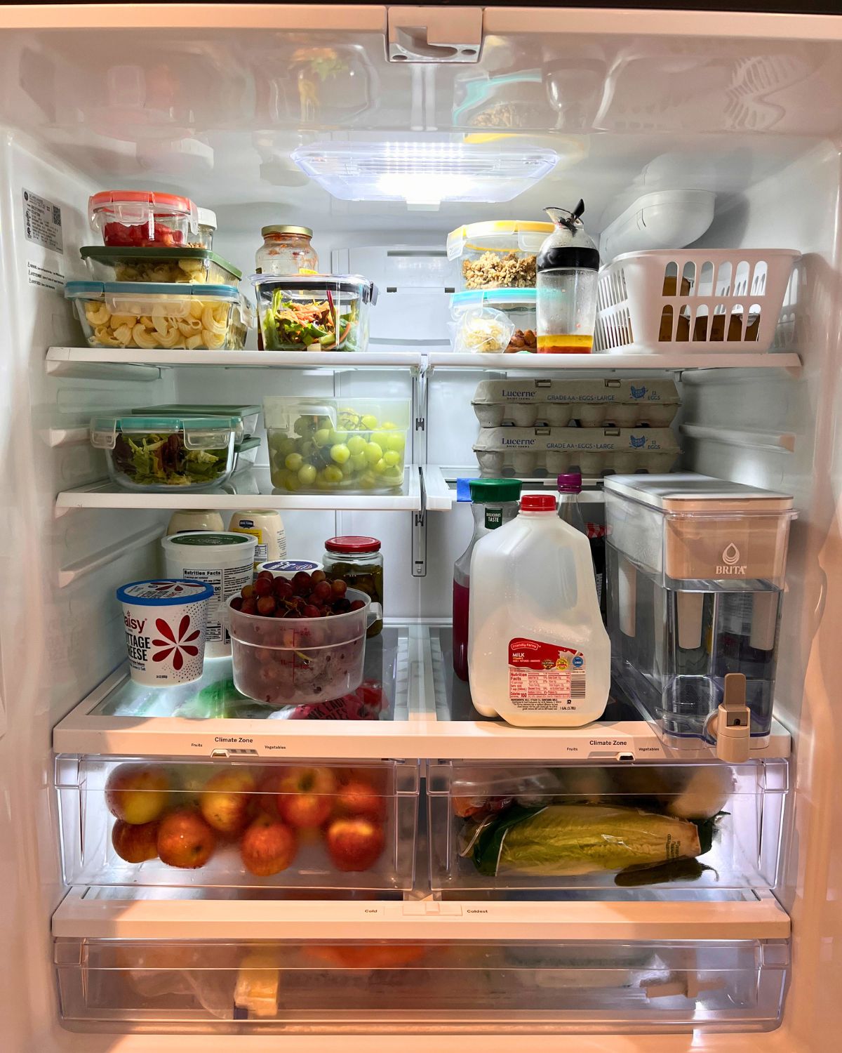 open fridge showing contents cleaned and organized.