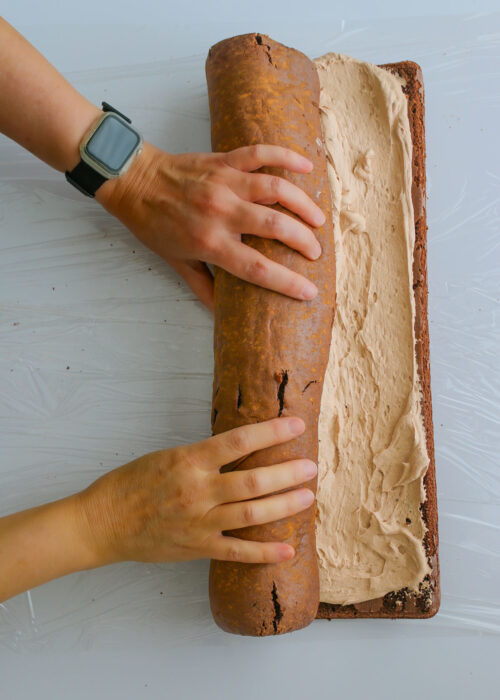 rolling the cake up with whipped cream filling.