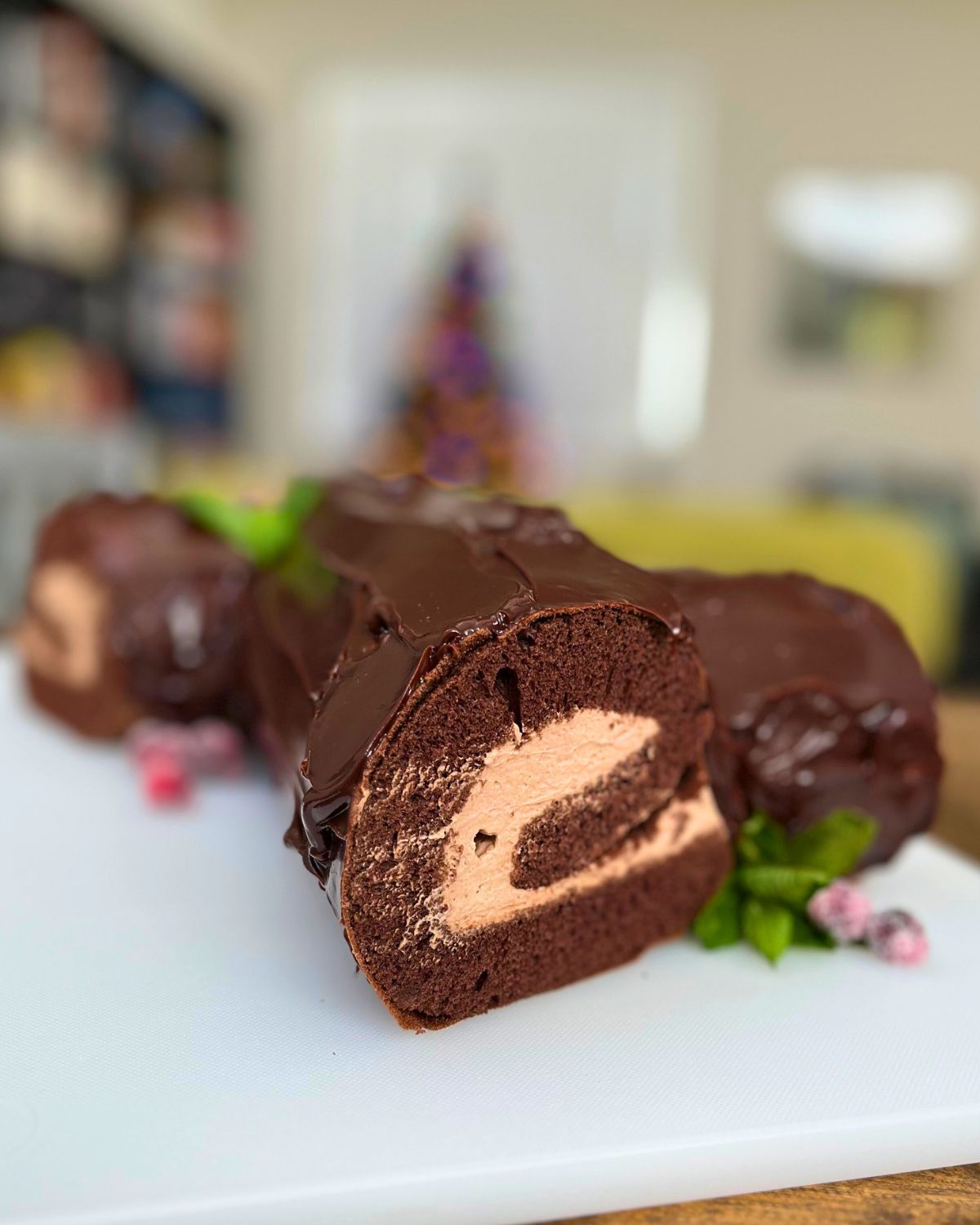 cake on table with tree in background, cut side showing.