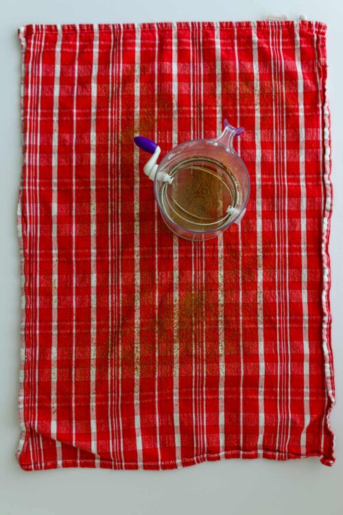 sifter of cocoa to sift cocoa powder over tea towel.