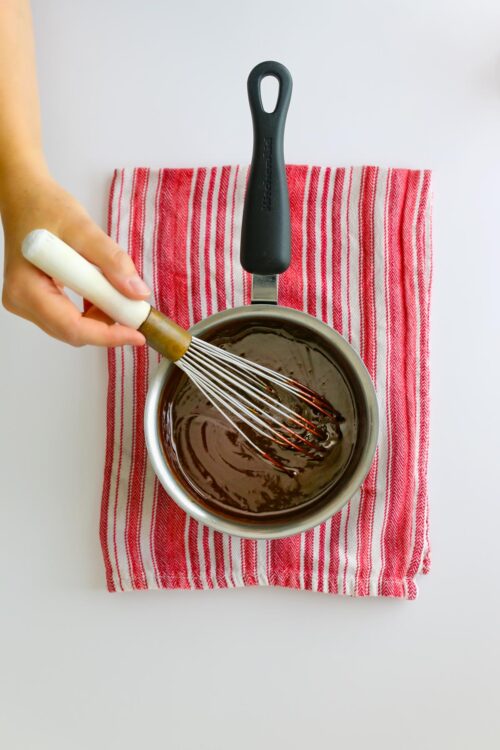 whisking the ganache in saucepan.