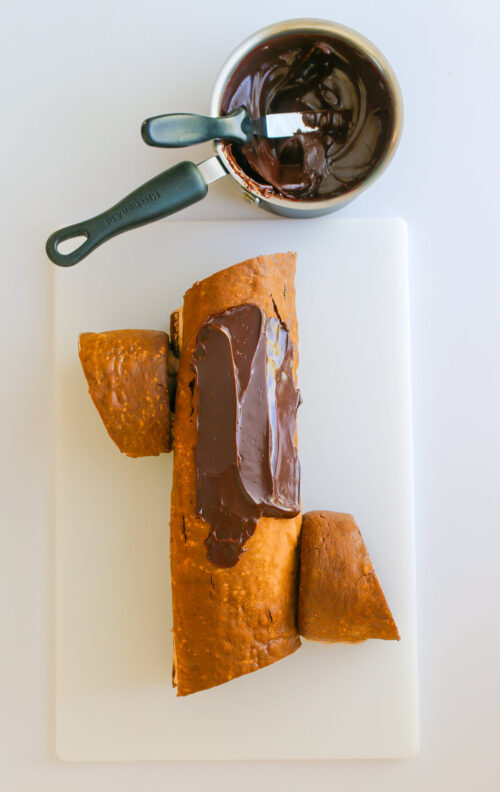 topping cake with ganache.