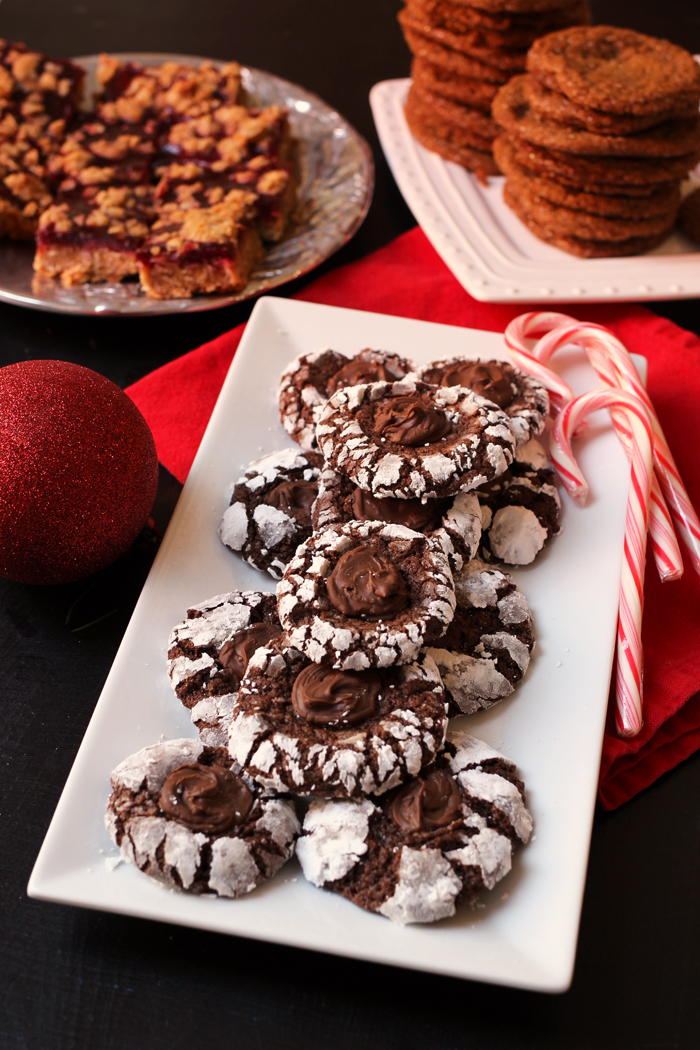 plate of Chocolate Crinkle Cookies with plates of other cookies