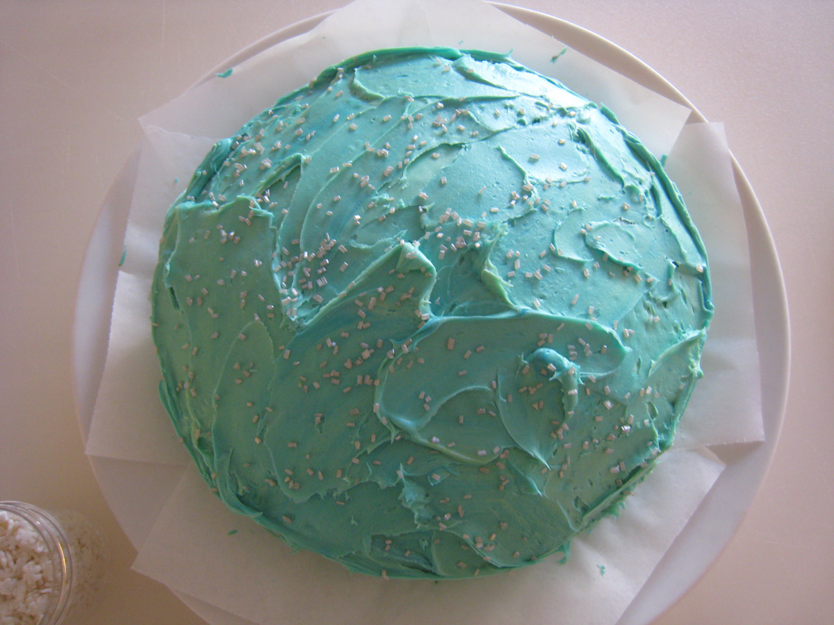frosted blue sea layer cake on plate.