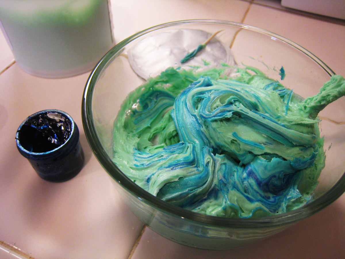 swirled blue green frosting in glass bowl.