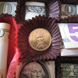 coins and bills in liners in chocolate box