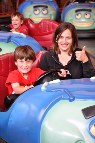 Mom and son in bumper car at Disneyland.