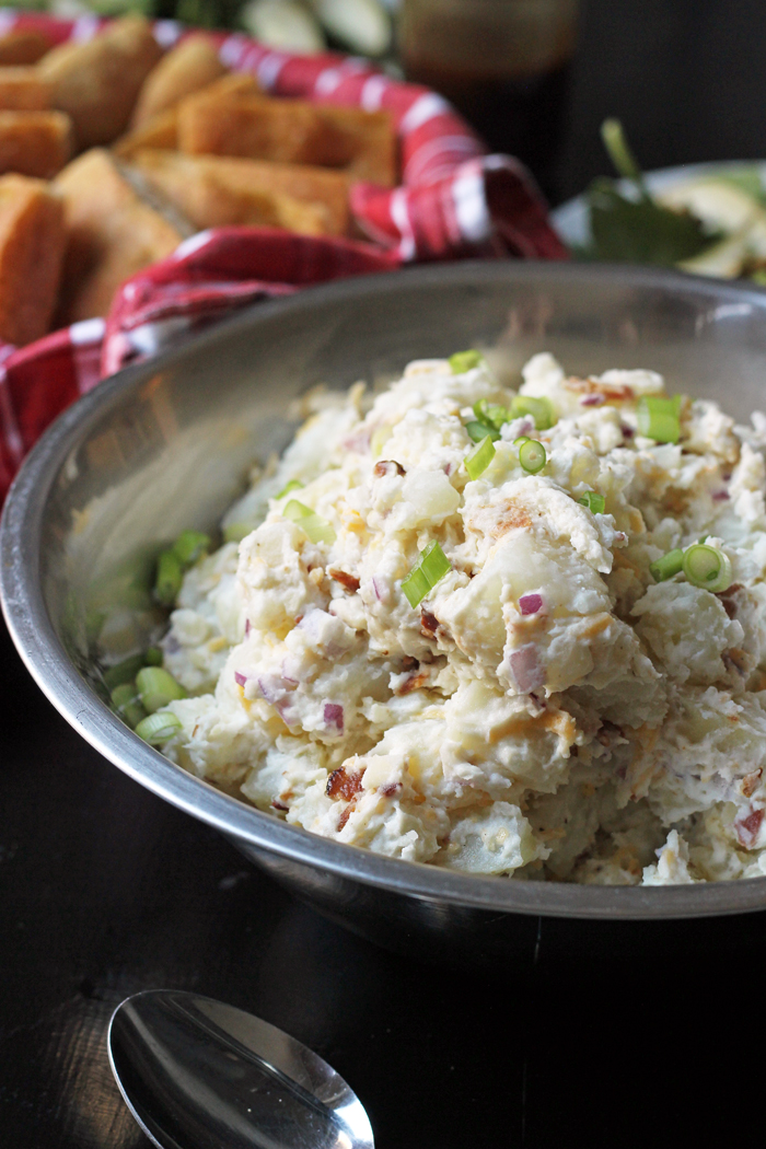 bowl of loaded potato salad with bread basket